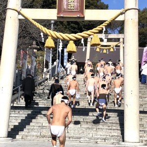 厄年の人、中心で海中禊の後、神社へ駆け上がる若い衆の元気な後ろ姿